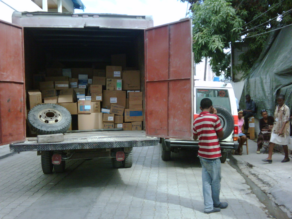 Man stands next truck in Haiti