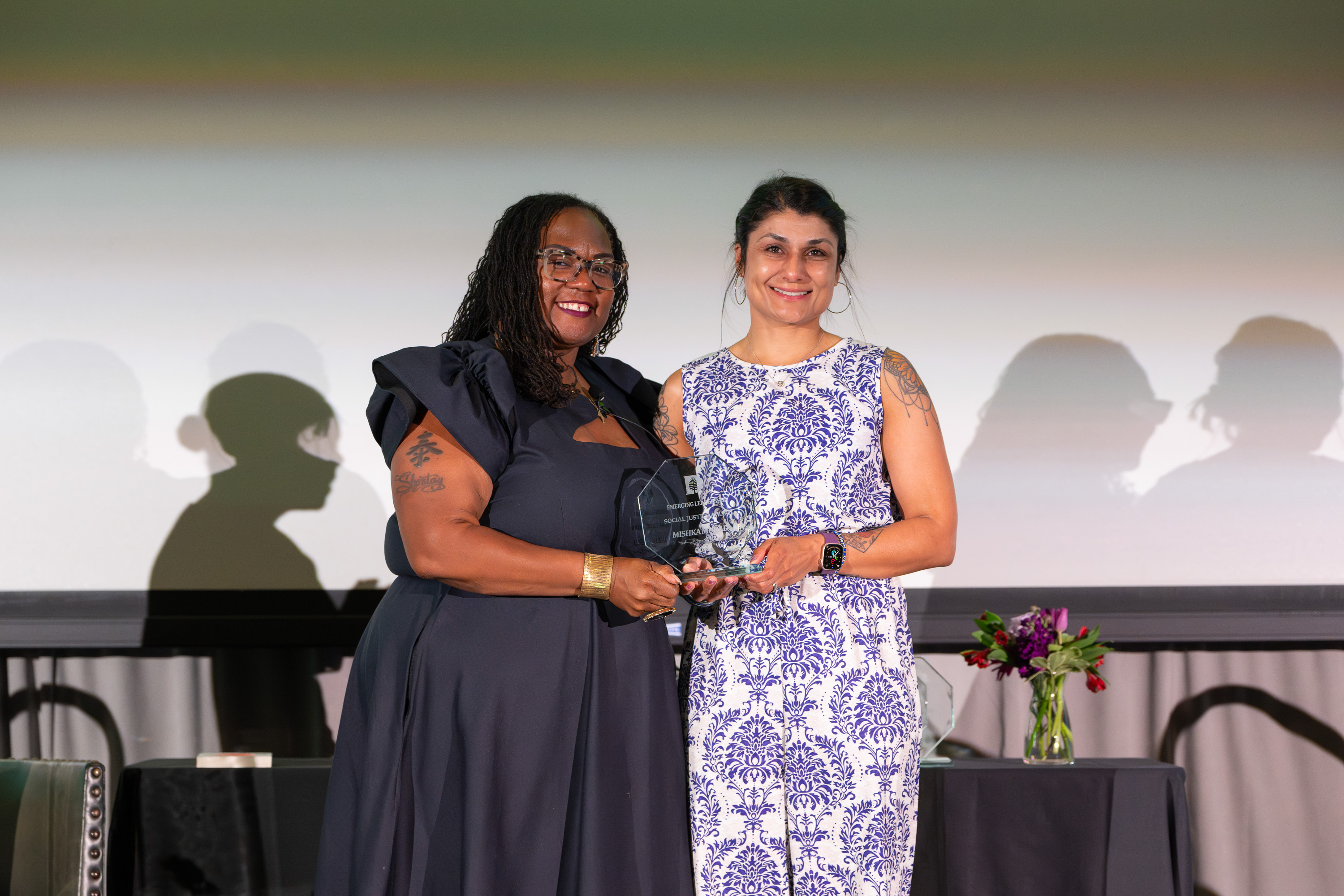 Dr. Mishka Murad accepting an award from Shontay Delalue