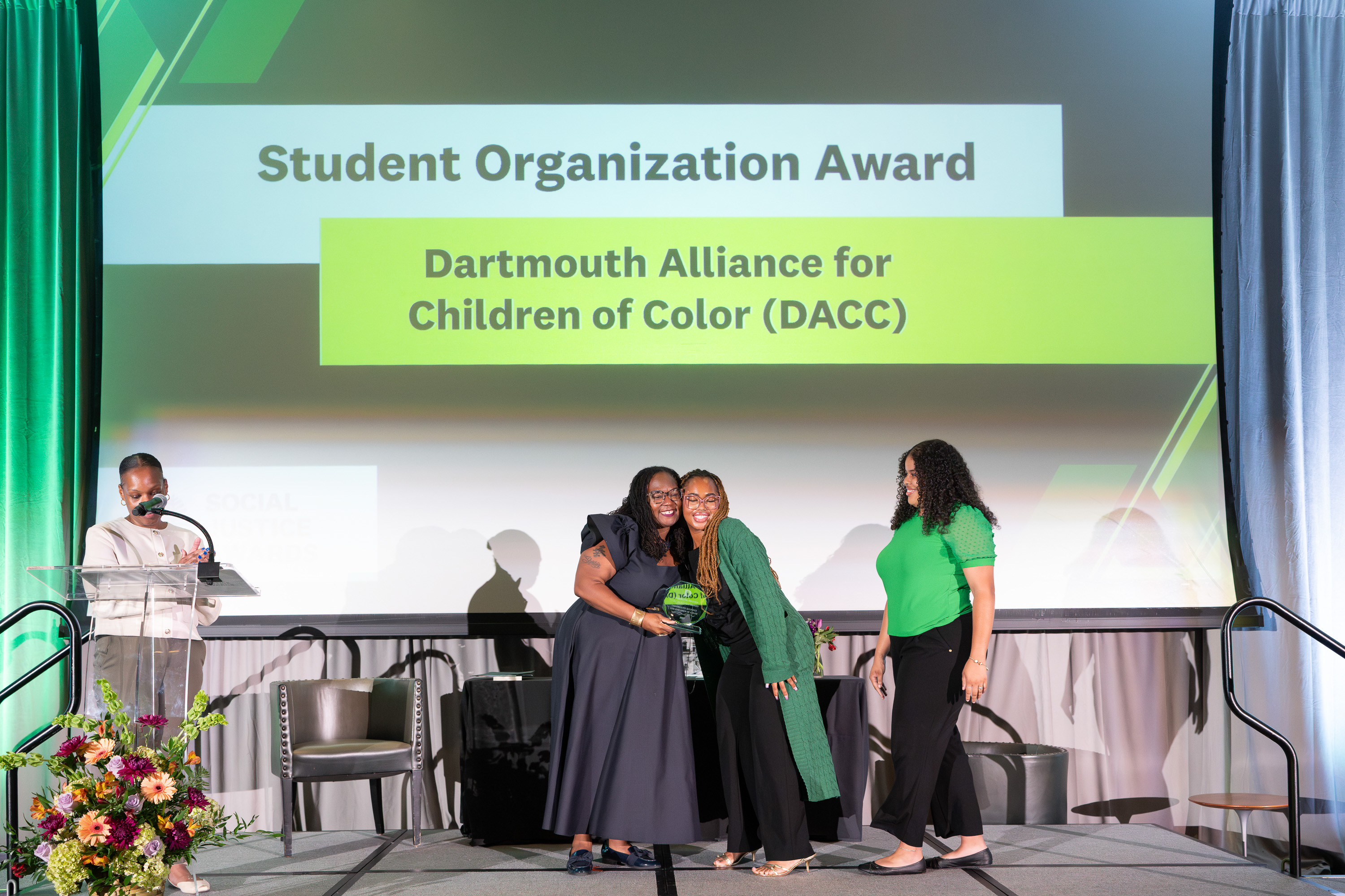 Cameron Moore and Elyjah McRae accepting an award from Shontay Delalue