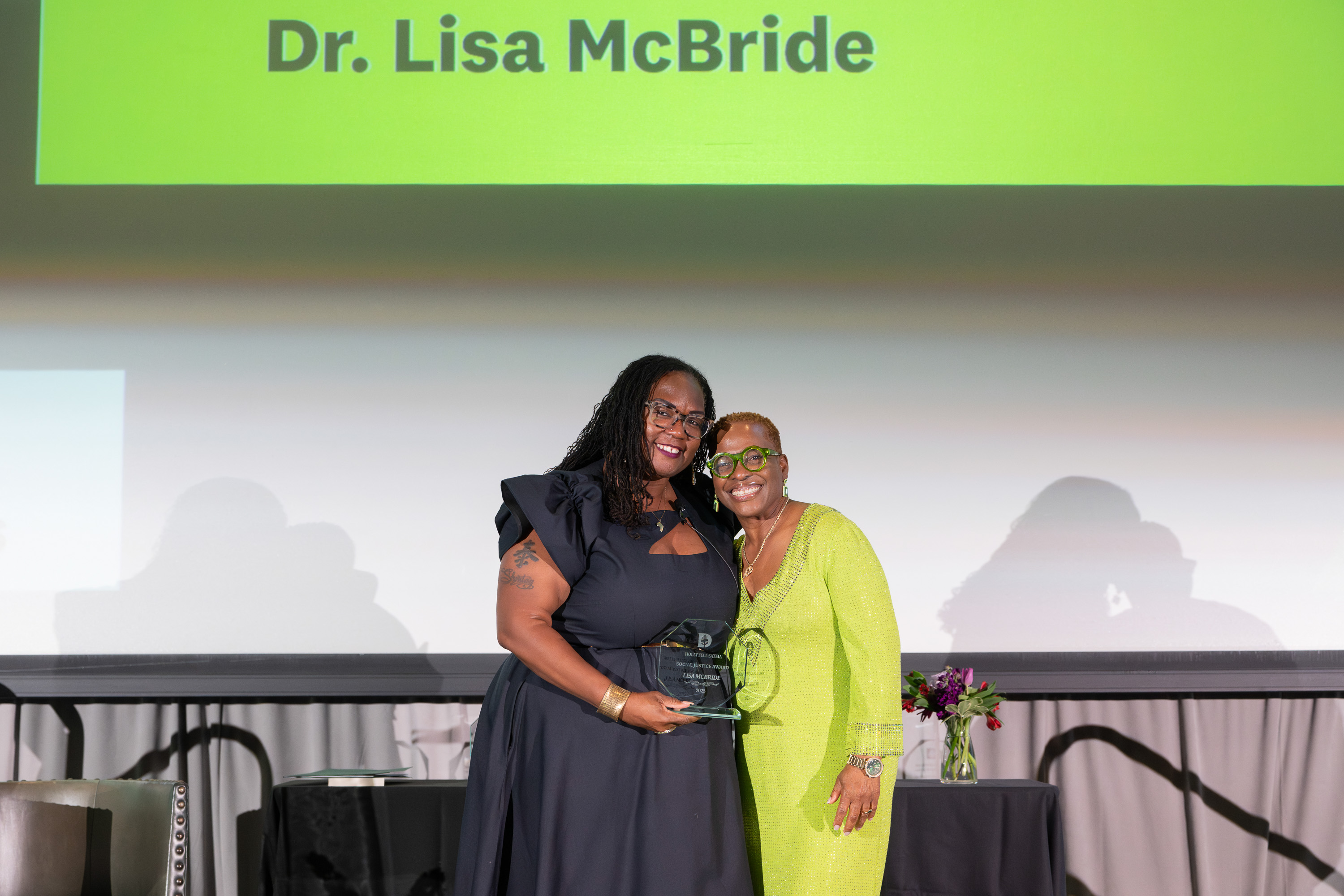 Dr. Lisa McBride accepting an award from Shontay Delalue