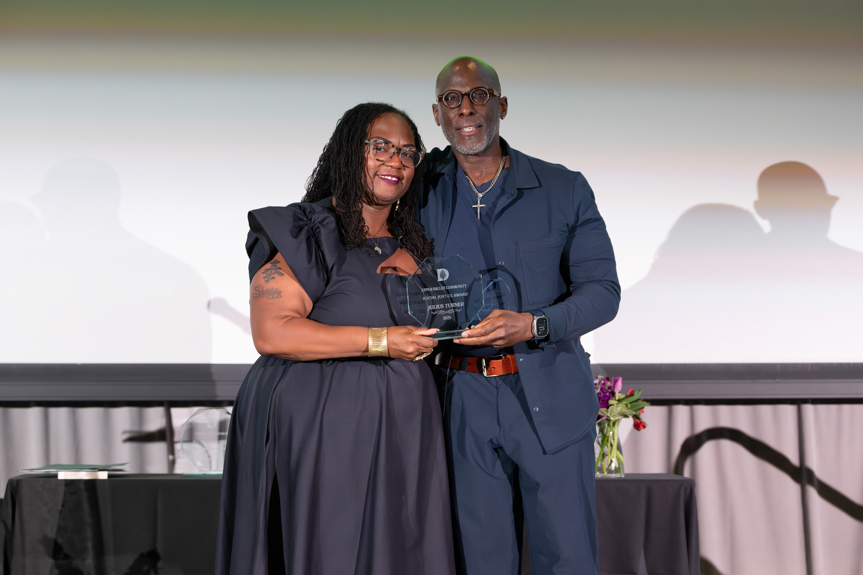 Julius Turner accepting an award from Shontay Delalue