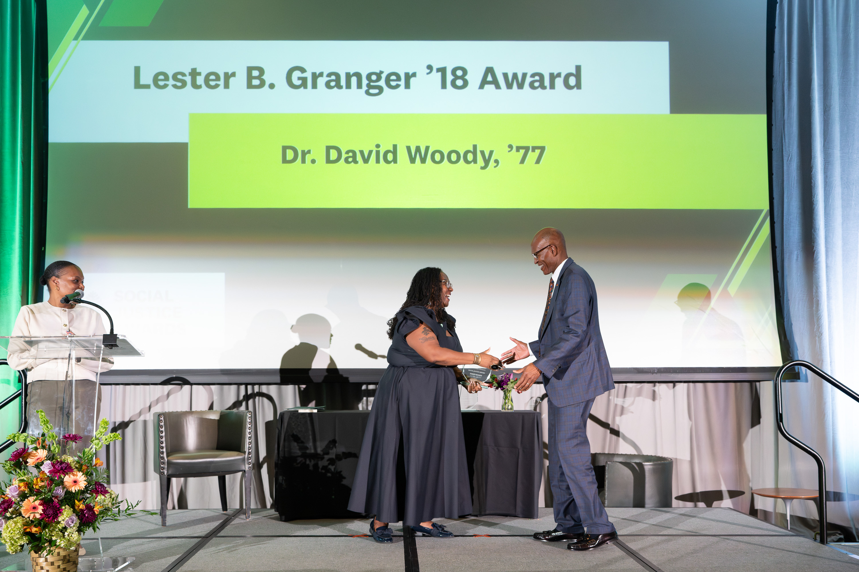 Dr. David Woody accepting an award from Shontay Delalue