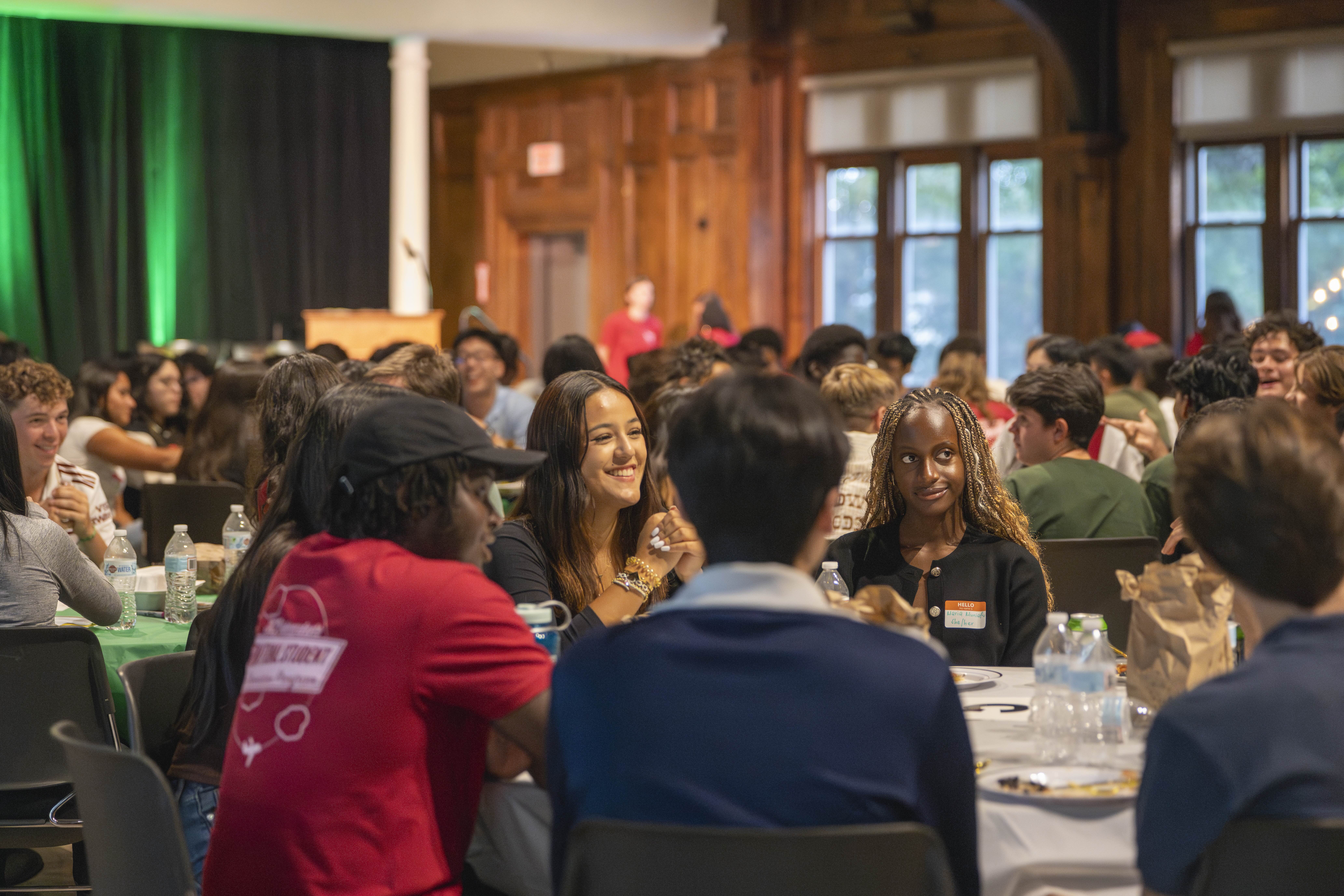 Students eating and chatting with their mentors at the International Student Banquet